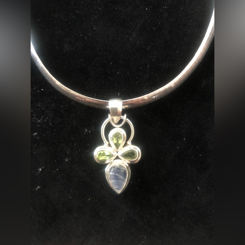 Sterling Silver with four semi precious teardrop stones.